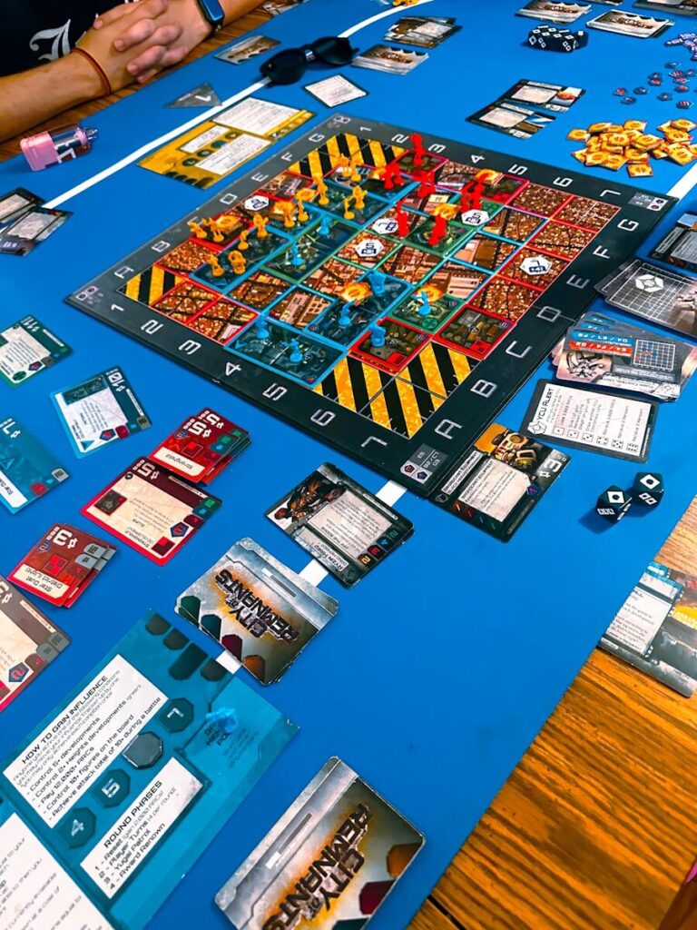 Board game with pieces and cards on blue table